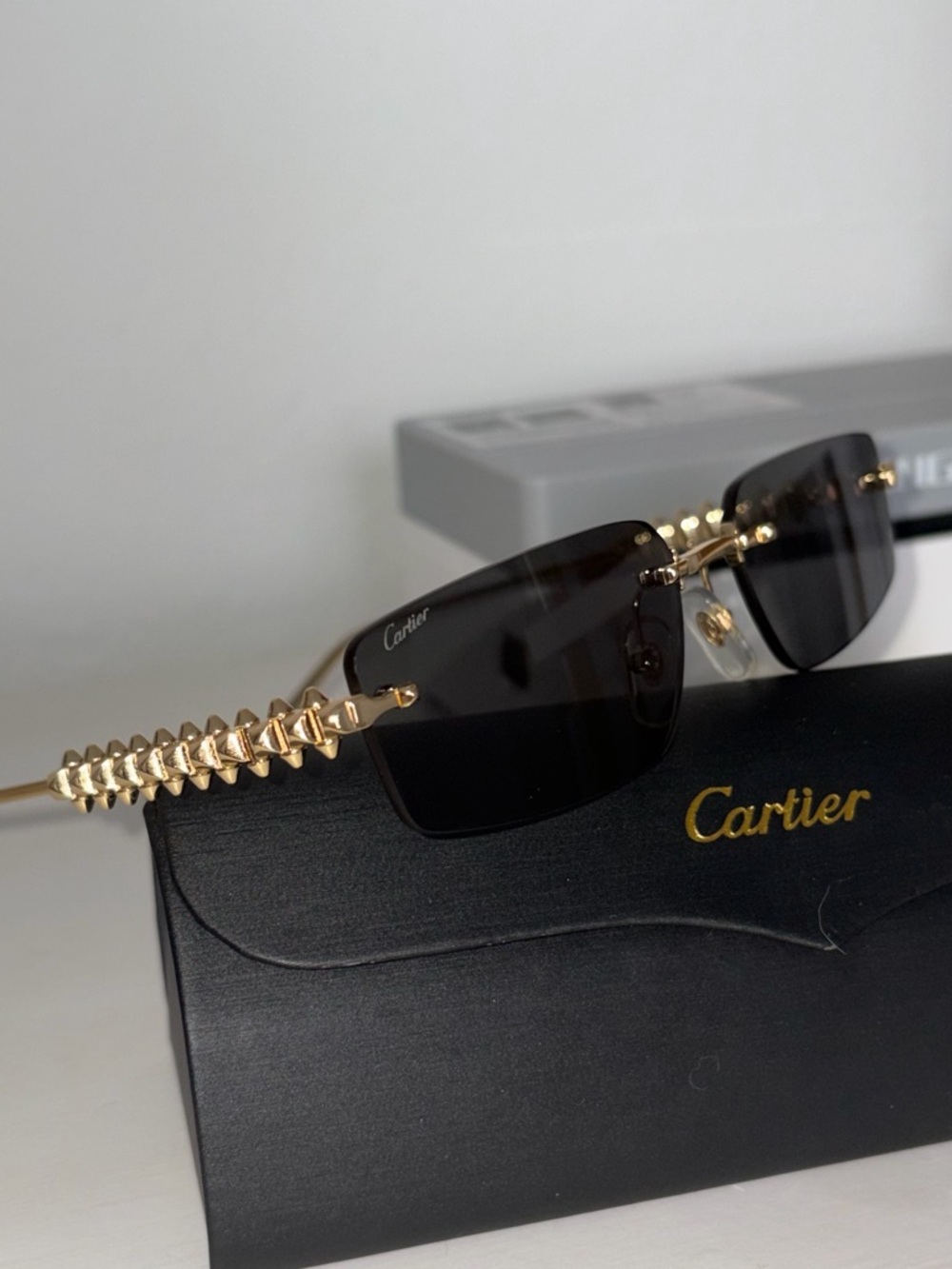 Cartier CT0544s Gold Rimless Sunglasses with Dark Lenses